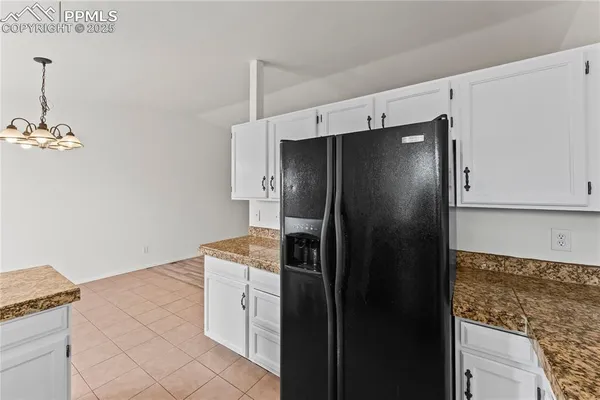 a kitchen with a refrigerator and a stove