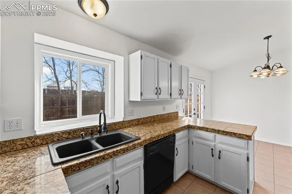a kitchen that has a sink and a stove