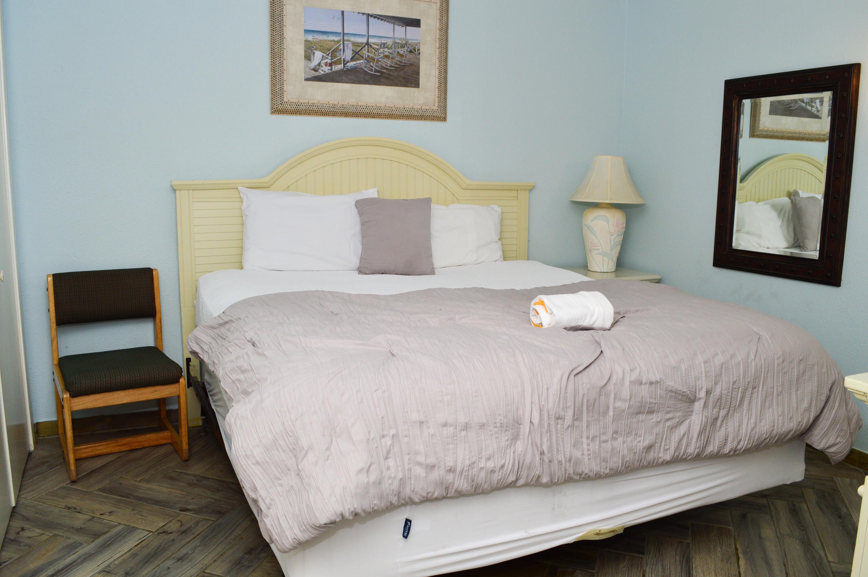 11483 Front Beach Road, Unit 307 Panama City Beach, FL 32407 - Photo 12 of 12 a bedroom with a bed and a painting on the wall