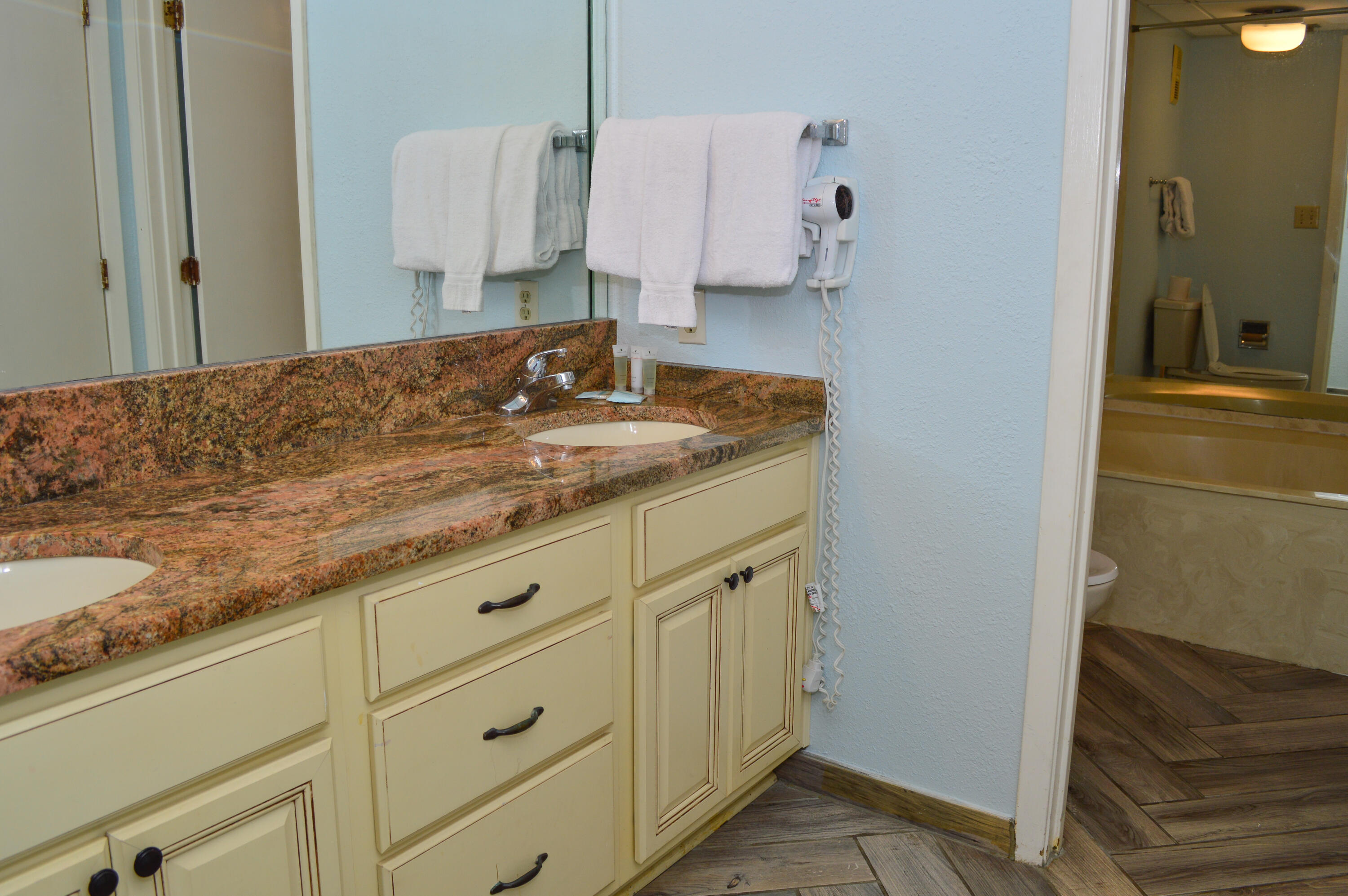 11483 Front Beach Road, Unit 307 Panama City Beach, FL 32407 - Photo 8 of 12 a bathroom with a granite countertop sink and a mirror