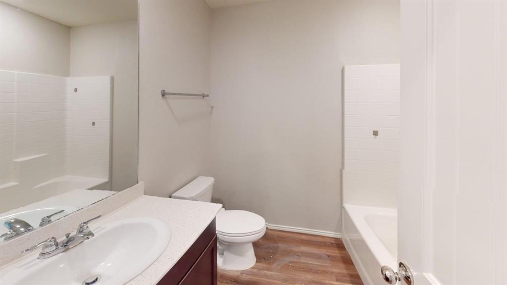331 Buckeye Avenue Princeton, TX 75407 - Photo 14 of 22 a white toilet sitting next to a bathroom sink