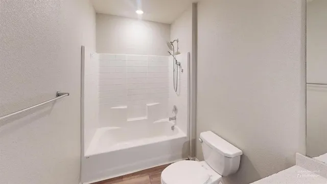 a bathroom with a toilet and a bathtub