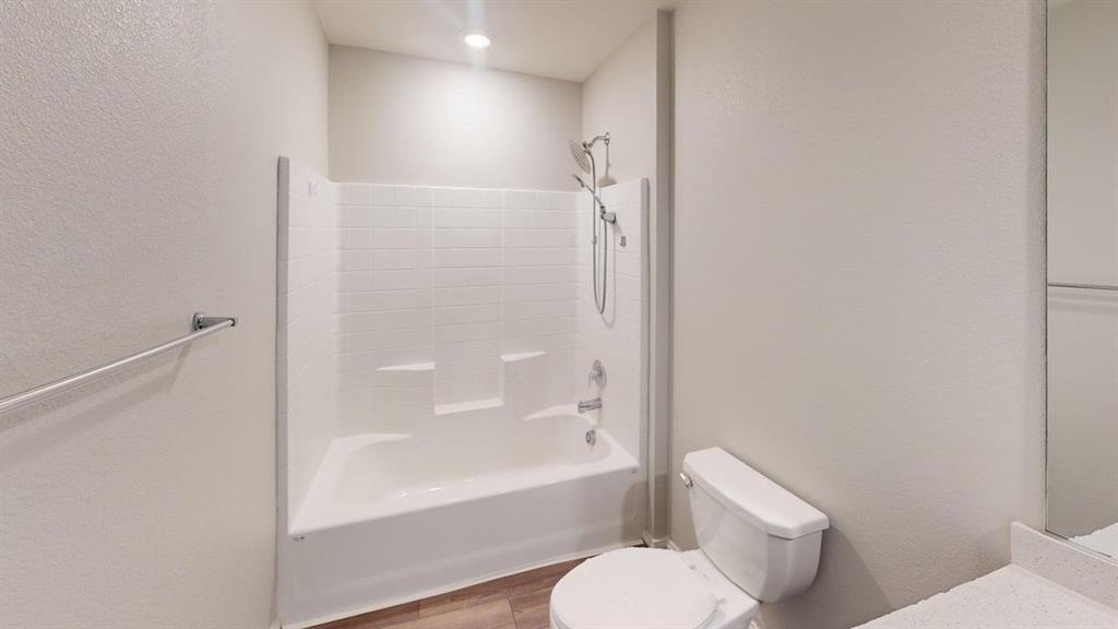 331 Buckeye Avenue Princeton, TX 75407 - Photo 16 of 22 a bathroom with a toilet and a bathtub