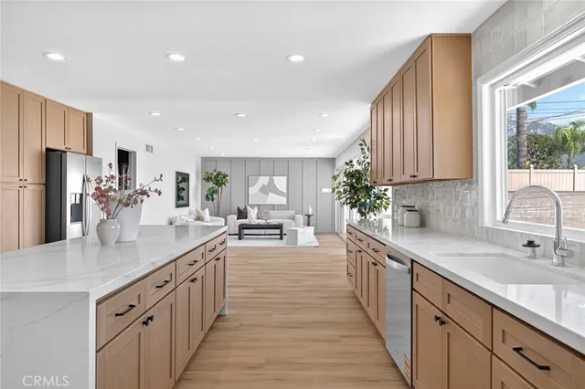 a kitchen with sink a counter top space and cabinets