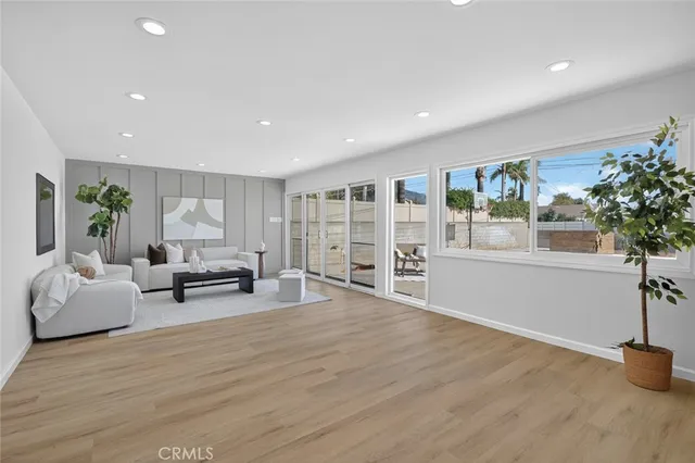 a living room with furniture and potted plant