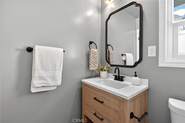 a bathroom with a sink vanity and a mirror