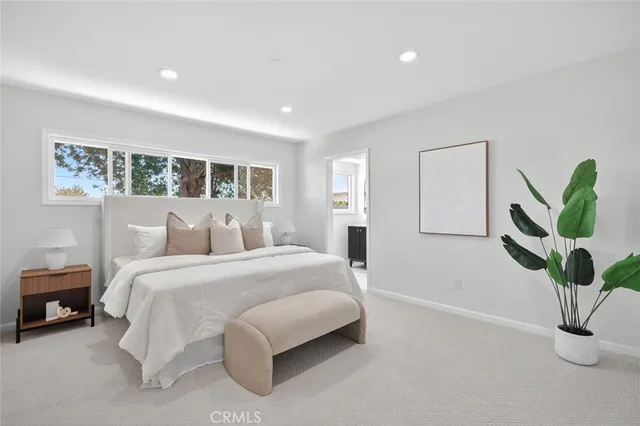 a bed room with a bed and a potted plant