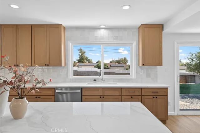 a kitchen with a sink stove and cabinets