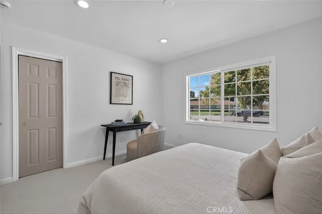 a bedroom with a bed and a window