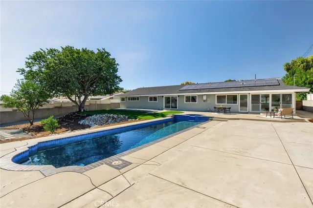 a house with swimming pool in front of it