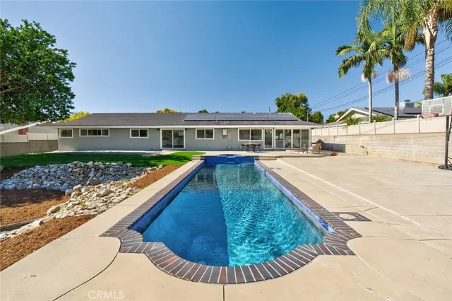 a view of swimming pool with outdoor seating and plants