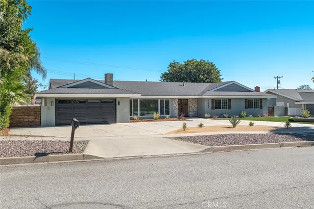 a front view of house with a garden