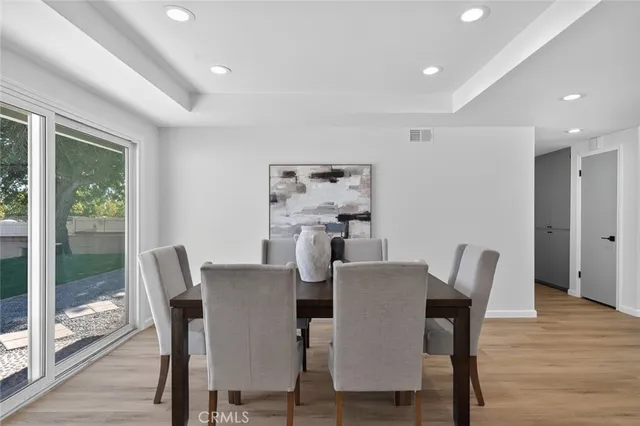 a view of a dining room with furniture window and wooden floor