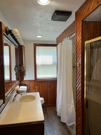 a bathroom with a sink a mirror and a shower