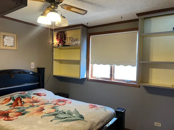 a large bed sitting in a bedroom next to a window