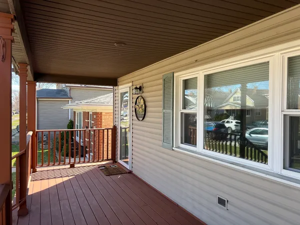 a view of a porch with wooden floor