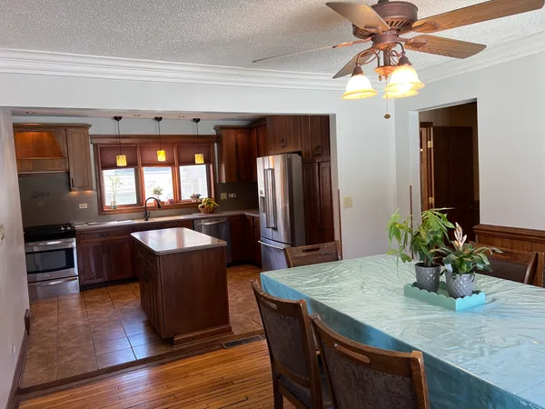 a kitchen with a table and chairs in it
