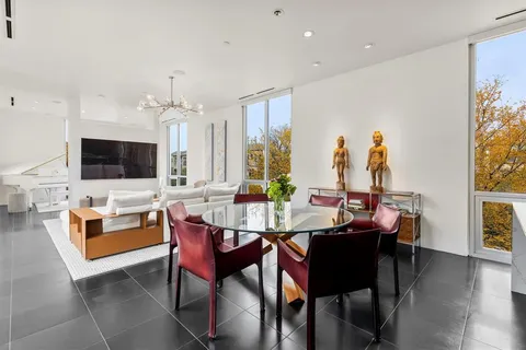 a view of a dining room with furniture and a livingroom