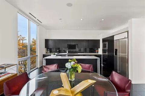 a kitchen with stainless steel appliances a sink stove and cabinets