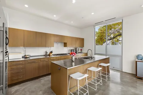 a kitchen with a sink dining table and chairs