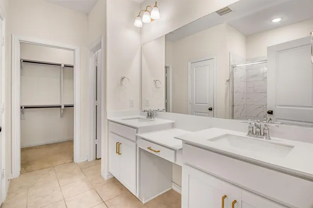 a bathroom with a sink double vanity and a mirror