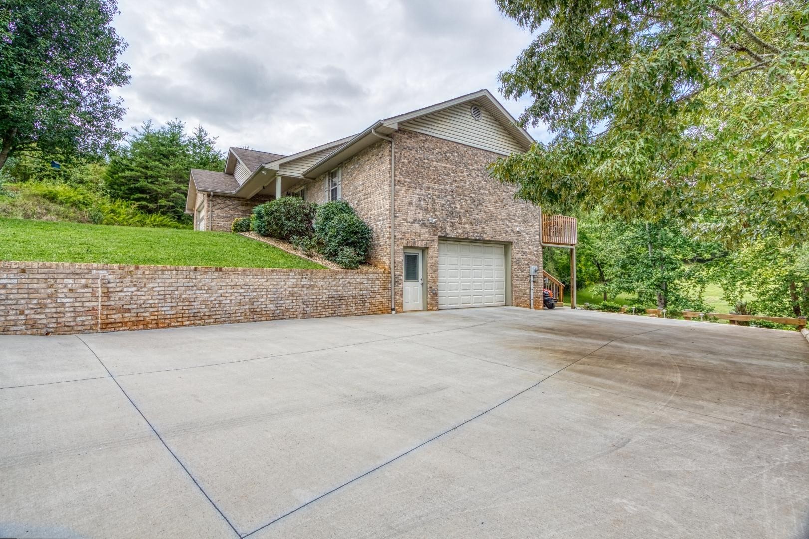 720 Rock House Road Kodak, TN 37764 - Photo 16 of 18 a front view of a house with a yard and garage
