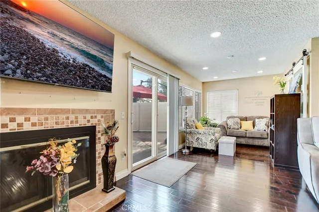 a living room with furniture wooden floor and a fireplace