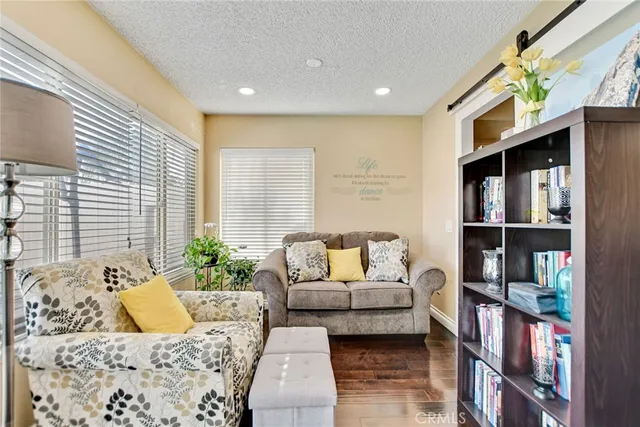 a living room with furniture and a book shelf