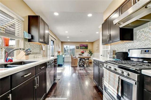 a kitchen with stainless steel appliances a stove sink microwave and cabinets
