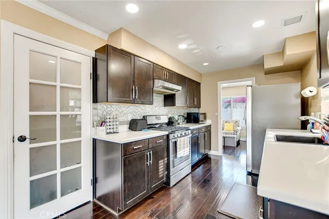 a kitchen with a sink cabinets and wooden floor