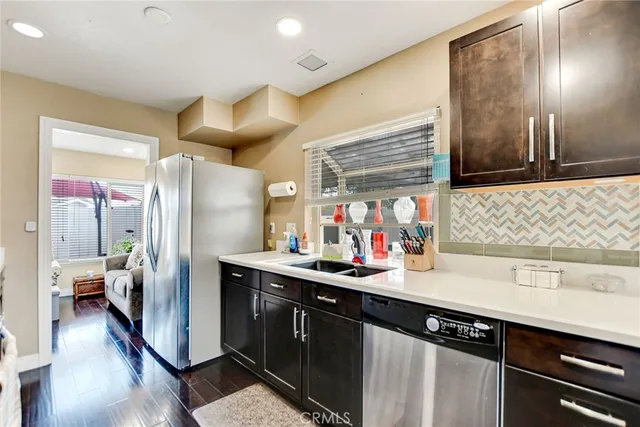 a kitchen with a sink appliances and cabinets