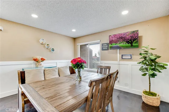 a dining room with furniture and potted plant