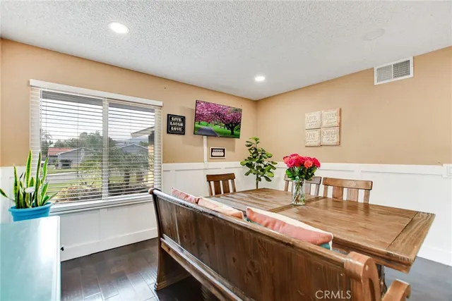 a dining room with furniture and a floor to ceiling window