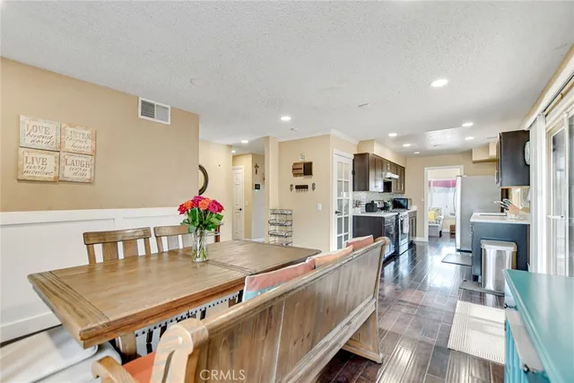 a living room with furniture dining table and wooden floor