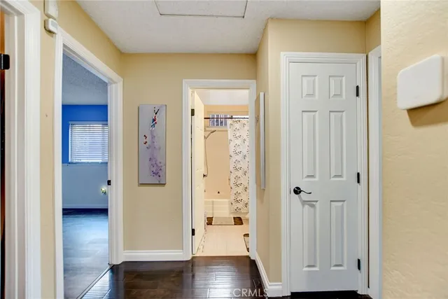 a view of a hallway with wooden floor