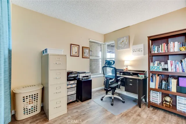 a view of a workspace with furniture and a bookshelf