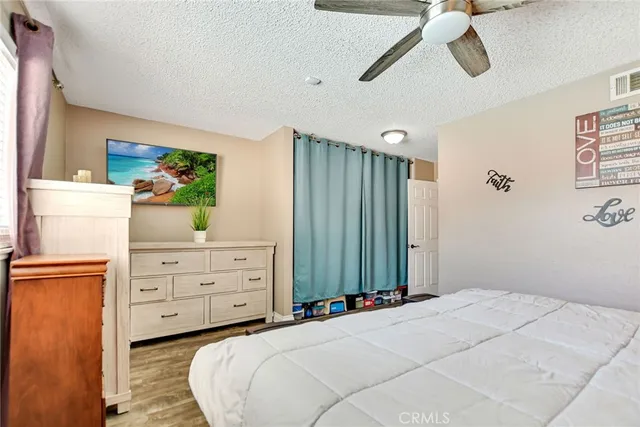 a bedroom with a bed dresser and a window