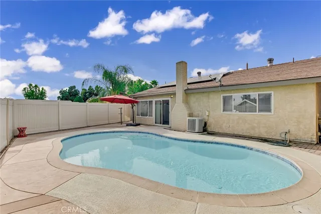 a view of a house with swimming pool and a yard