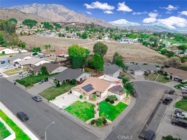 an aerial view of residential houses with outdoor space and street view