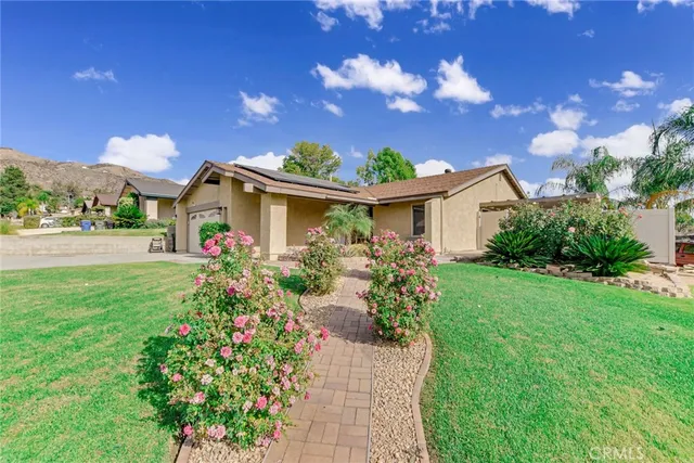 a front view of a house with garden