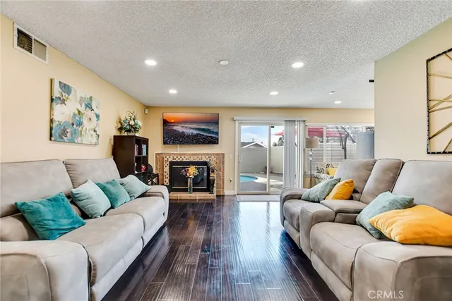 a living room with furniture fireplace and flat screen tv