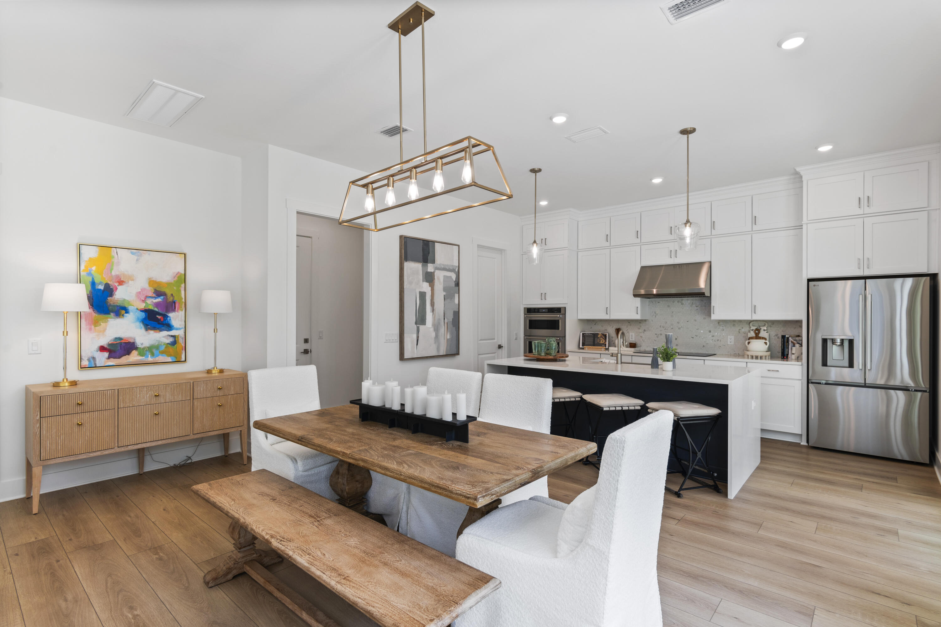 a living room with kitchen island furniture and a kitchen view