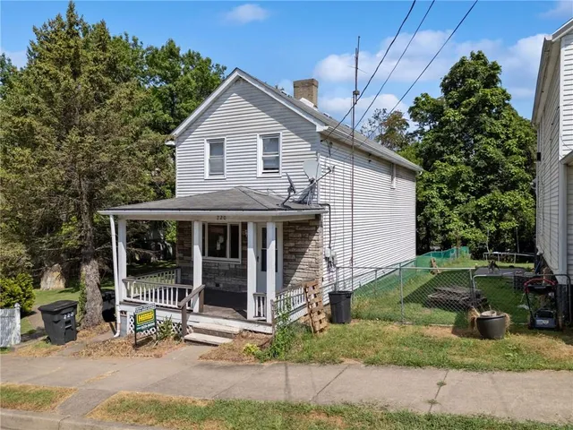 a view of a house with a yard and plants