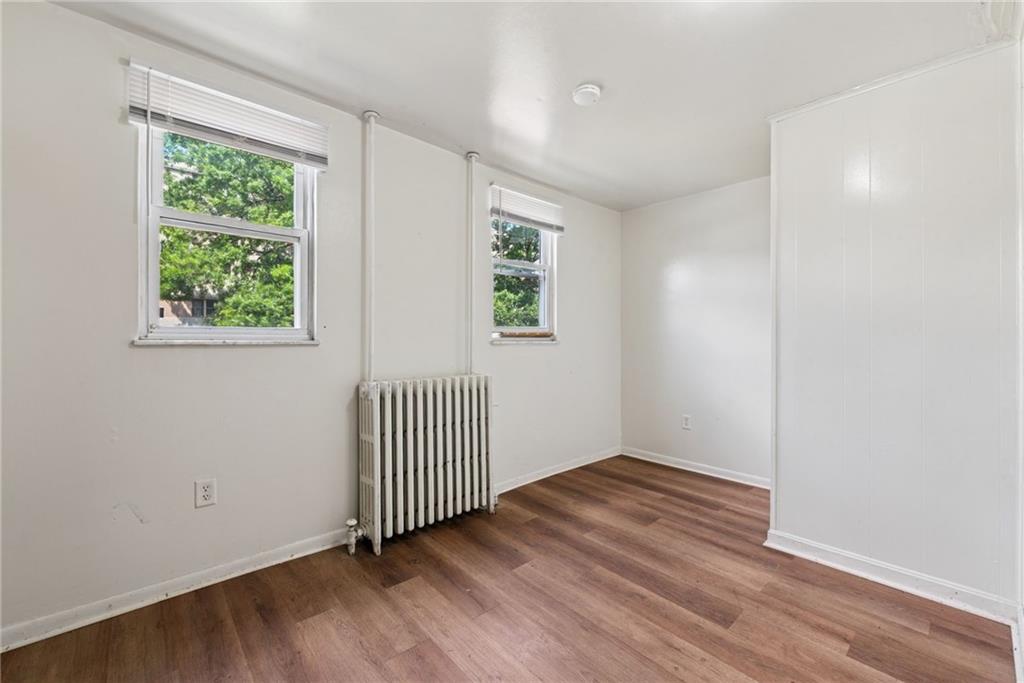 220 Oneida Street Monessen, PA 15062 - Photo 12 of 28 an empty room with wooden floor and windows