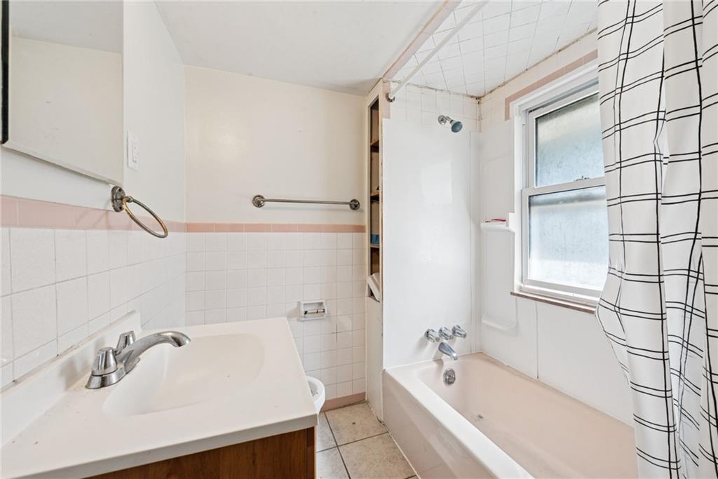 220 Oneida Street Monessen, PA 15062 - Photo 20 of 28 a bathroom with a tub sink and mirror
