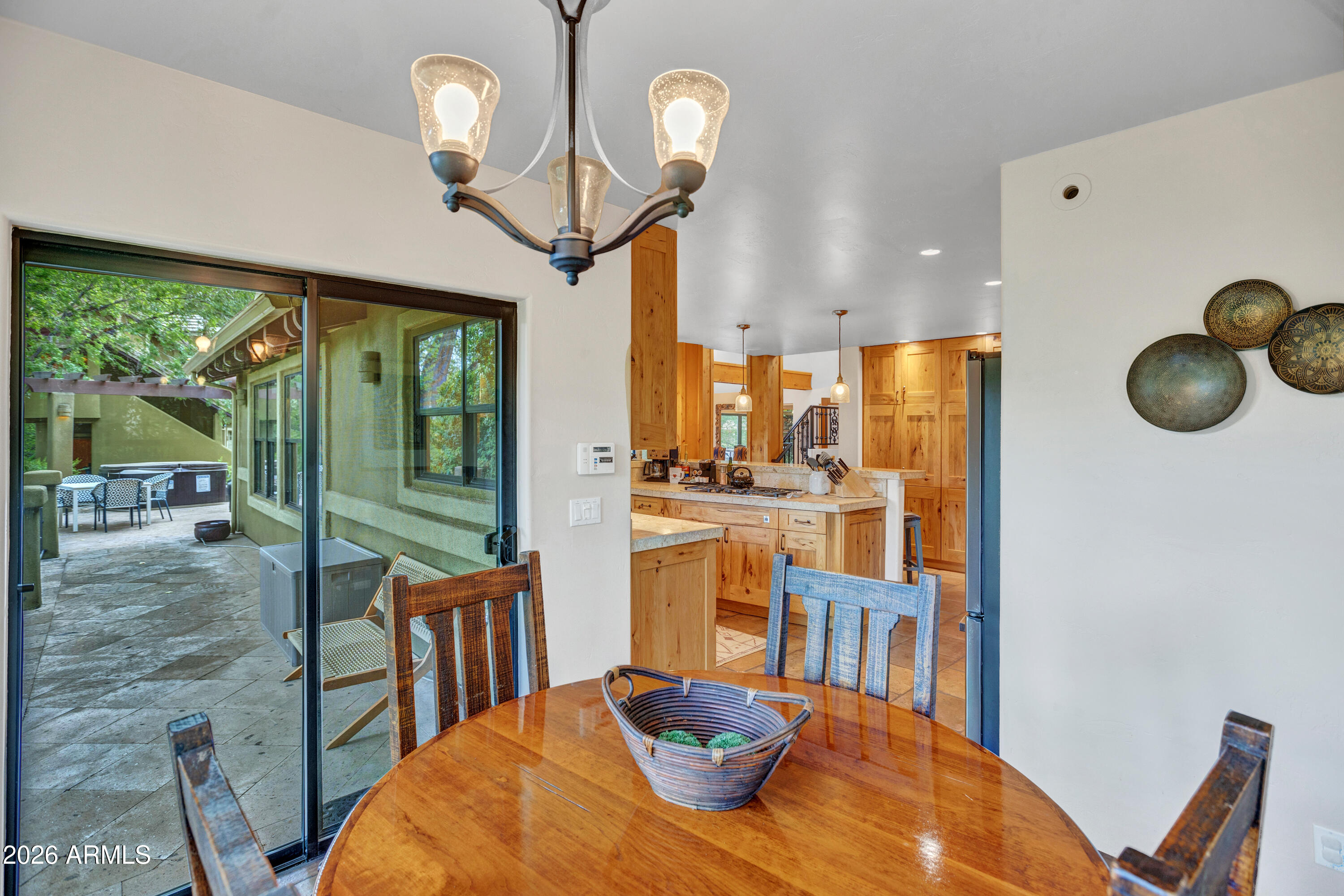 55 Ranch House Circle Sedona, AZ 86336 - Photo 19 of 61 a view of a dining room with furniture a chandelier and large windows