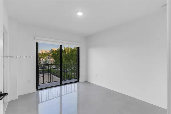 a view of an empty room with glass door