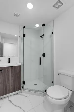 a bathroom with a toilet and a shower