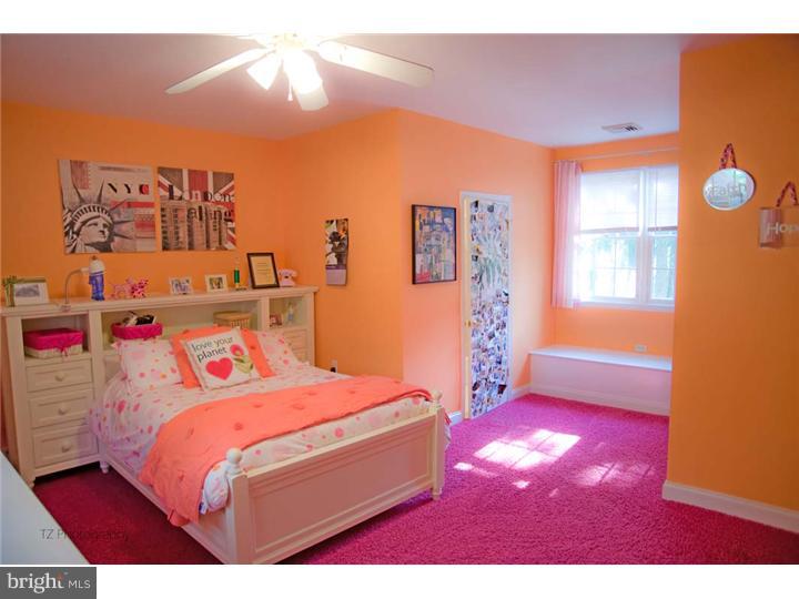 1 Rose Hill Road Media, PA 19063 - Photo 21 of 24 a bedroom with a bed and a chandelier