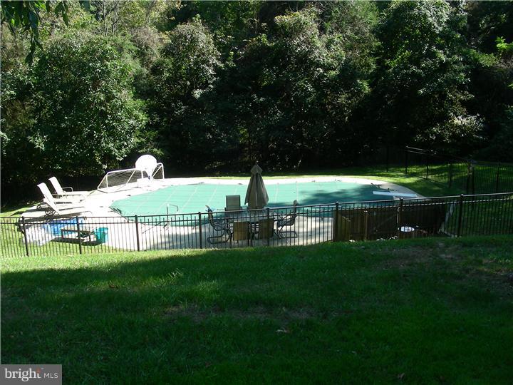 1 Rose Hill Road Media, PA 19063 - Photo 23 of 24 a view of a garden with lawn chairs and a large tree